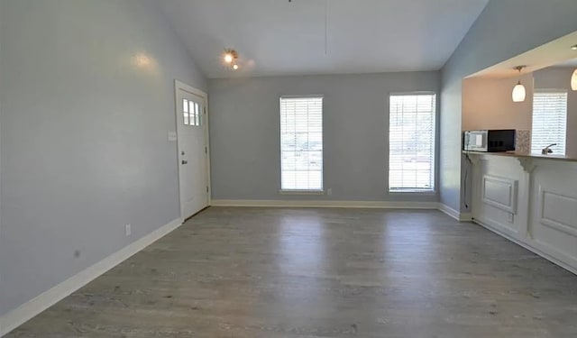 interior space featuring vaulted ceiling and hardwood / wood-style floors