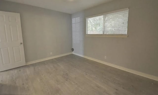 spare room featuring hardwood / wood-style floors