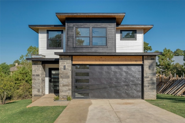 modern home with a garage and a front lawn