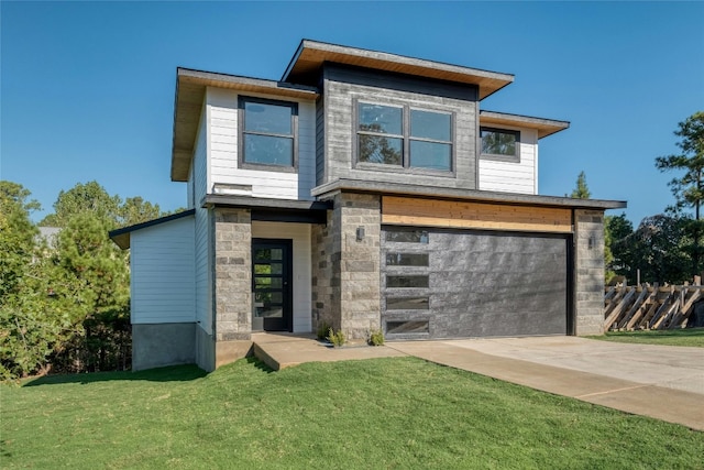 contemporary home with a garage and a front yard