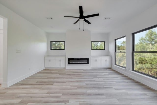 unfurnished living room featuring light wood-type flooring and ceiling fan