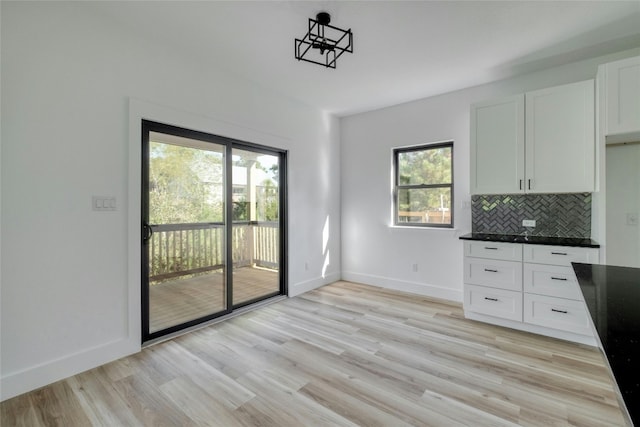 unfurnished dining area featuring light hardwood / wood-style floors and a healthy amount of sunlight