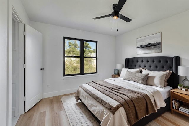 bedroom with light hardwood / wood-style floors and ceiling fan