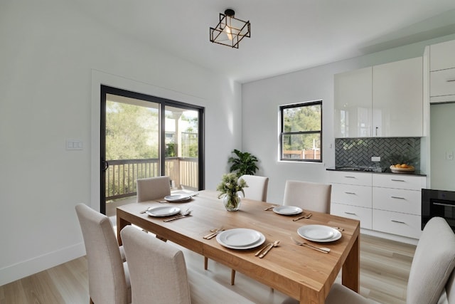 dining room with light hardwood / wood-style floors and a healthy amount of sunlight