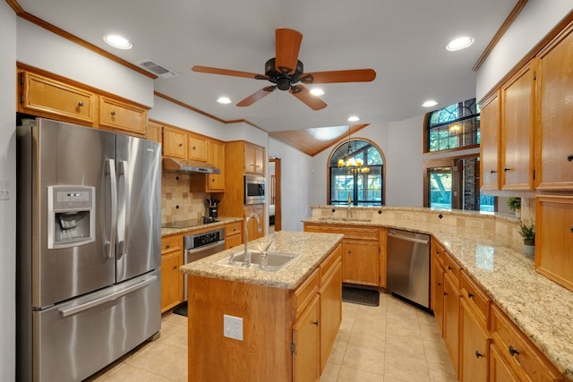 kitchen with light stone counters, sink, kitchen peninsula, a center island with sink, and appliances with stainless steel finishes