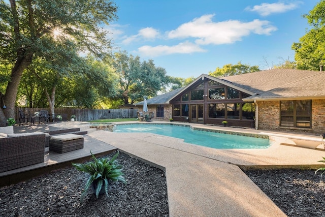 view of pool featuring outdoor lounge area and a patio