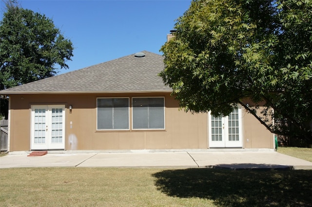 back of house with a patio, a yard, and french doors