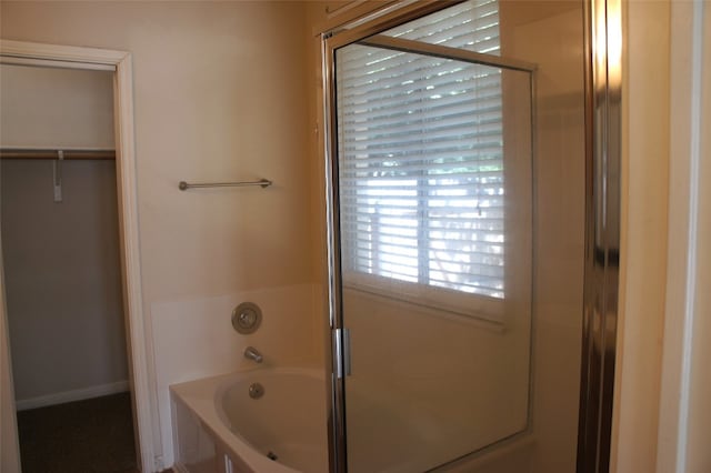 bathroom featuring separate shower and tub