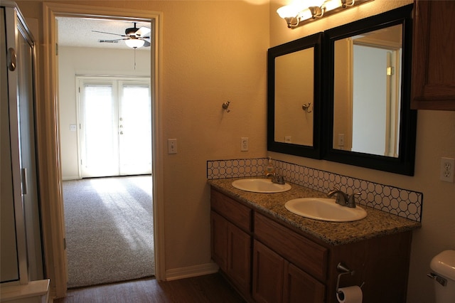 bathroom featuring a textured ceiling, vanity, toilet, and ceiling fan