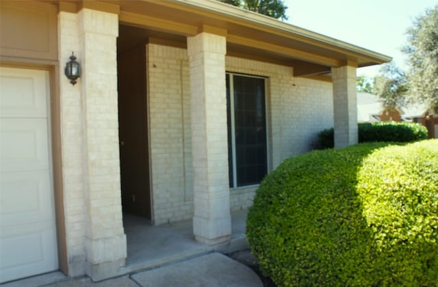 view of exterior entry with a garage