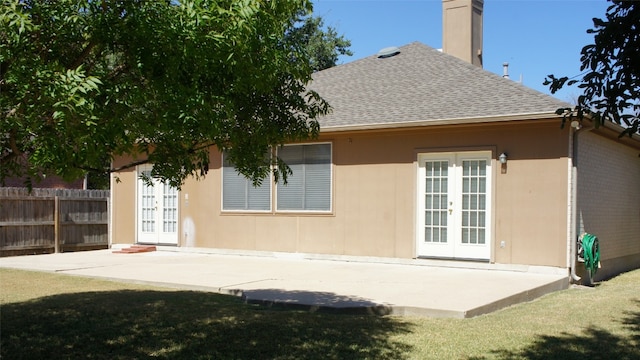 back of house with french doors, a yard, and a patio area