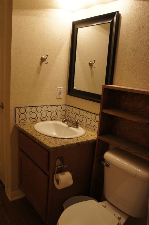 bathroom featuring vanity and toilet