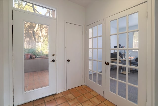 doorway with french doors and light tile patterned flooring