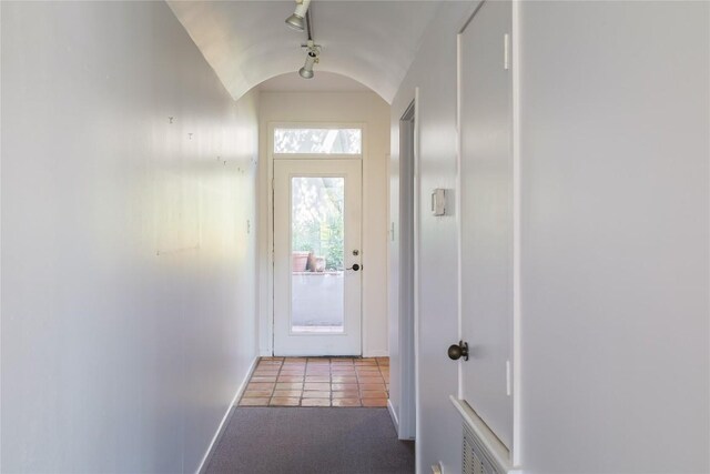 1707 Spyglass Dr Unit 57, Austin, TX 78746 - doorway featuring lofted ceiling, baseboards, and tile patterned flooring