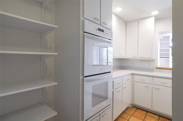 1707 Spyglass Dr Unit 57, Austin, TX 78746 - kitchen featuring open shelves, double oven, light countertops, white cabinets, and recessed lighting