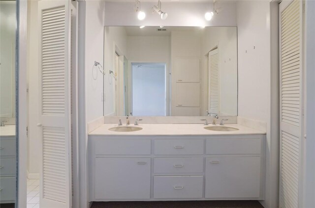 1707 Spyglass Dr Unit 57, Austin, TX 78746 - bathroom featuring a closet, double vanity, and tile patterned floors