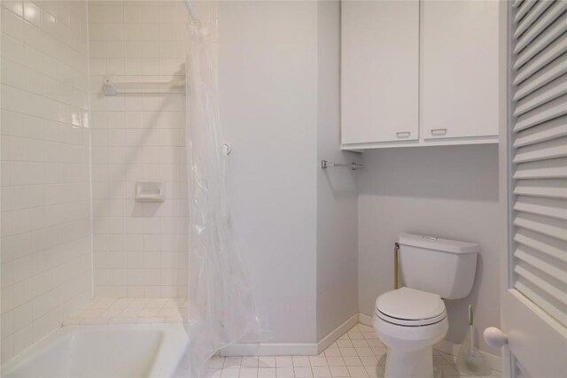 1707 Spyglass Dr Unit 57, Austin, TX 78746 - bathroom featuring a towel warmer, toilet, tile patterned floors, and shower / bath combo with shower curtain