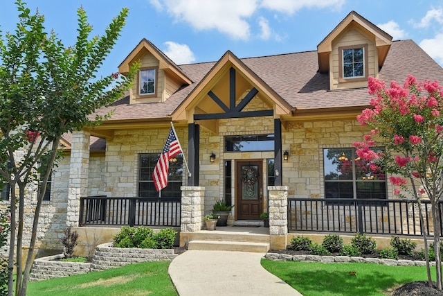 view of front of home with covered porch and a front yard