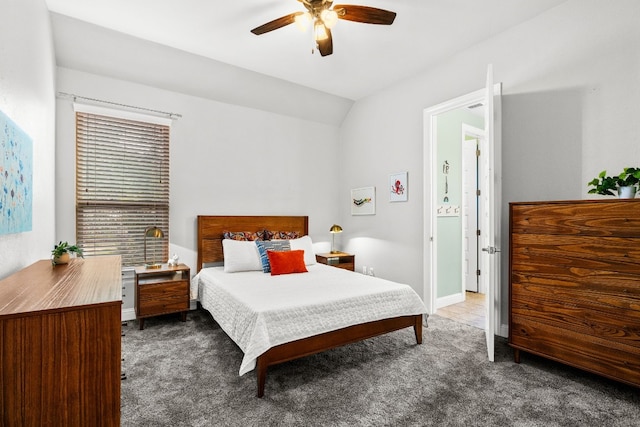 bedroom with dark colored carpet, ceiling fan, and vaulted ceiling