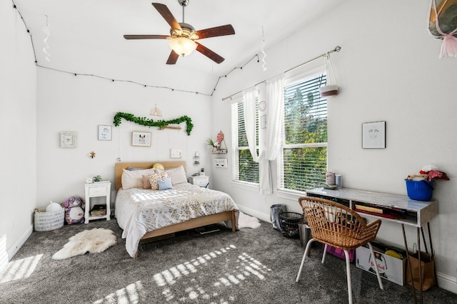 carpeted bedroom featuring vaulted ceiling and ceiling fan