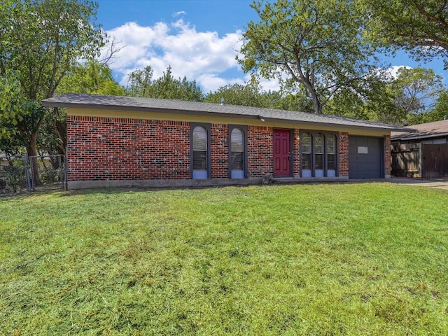 ranch-style home with a garage and a front lawn