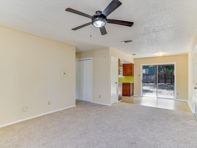 unfurnished living room with ceiling fan and light colored carpet