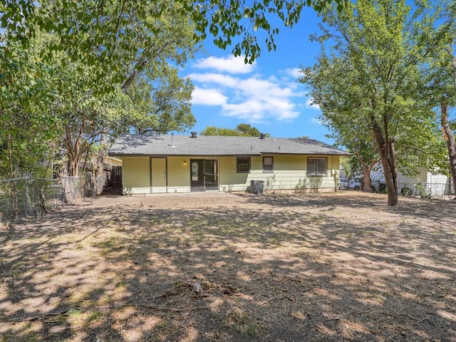 rear view of house featuring central AC