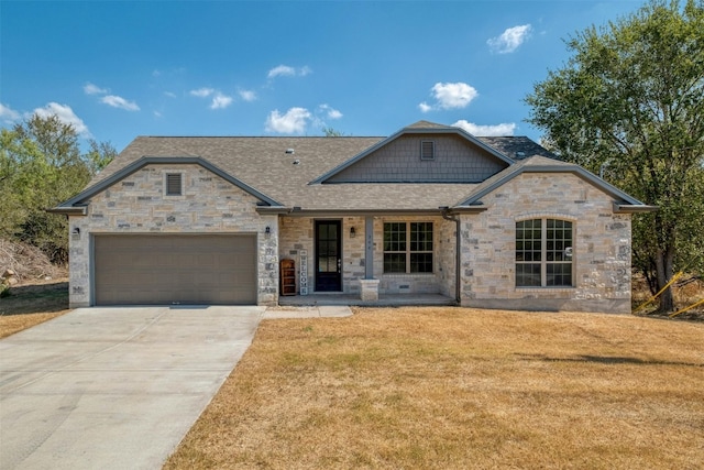 view of front of home with a garage and a front lawn