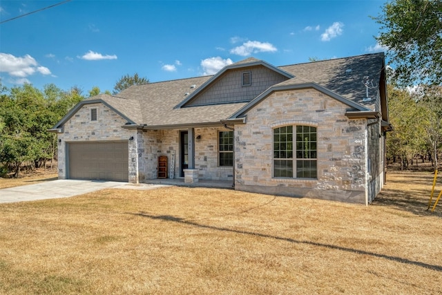 view of front of home featuring a garage and a front lawn