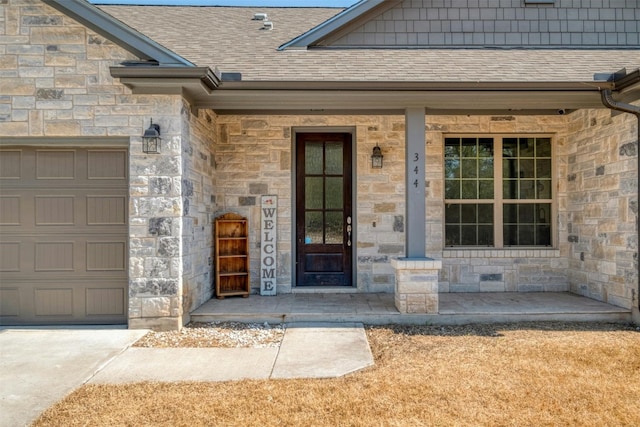 view of exterior entry featuring a porch and a garage