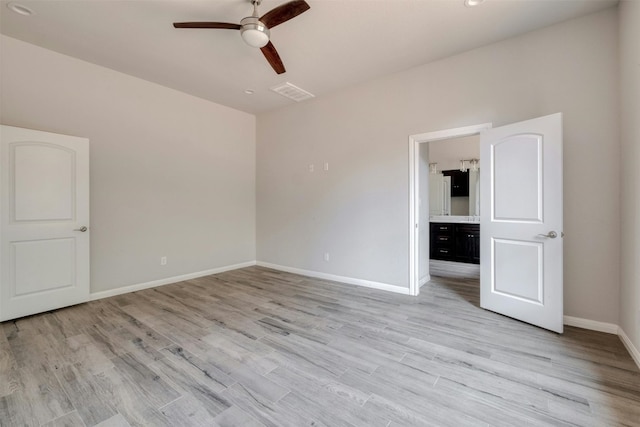 unfurnished bedroom with ceiling fan, light wood-type flooring, and connected bathroom