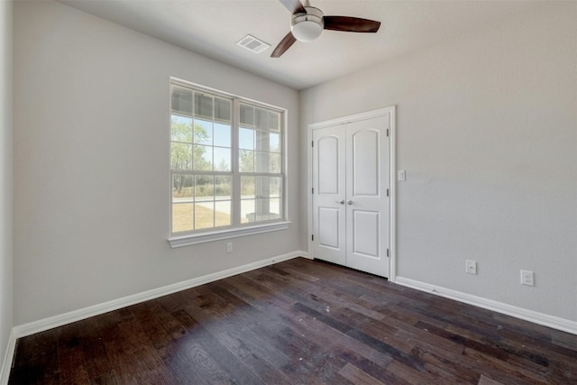 spare room featuring dark hardwood / wood-style floors and ceiling fan