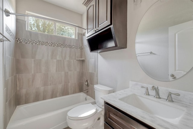 full bathroom featuring tiled shower / bath combo, vanity, and toilet