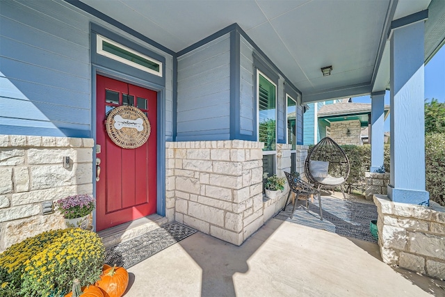 view of exterior entry with a porch