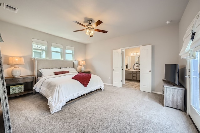 carpeted bedroom with ceiling fan and ensuite bath