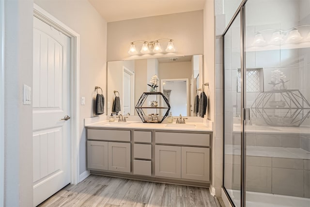 bathroom featuring vanity, an enclosed shower, and hardwood / wood-style flooring