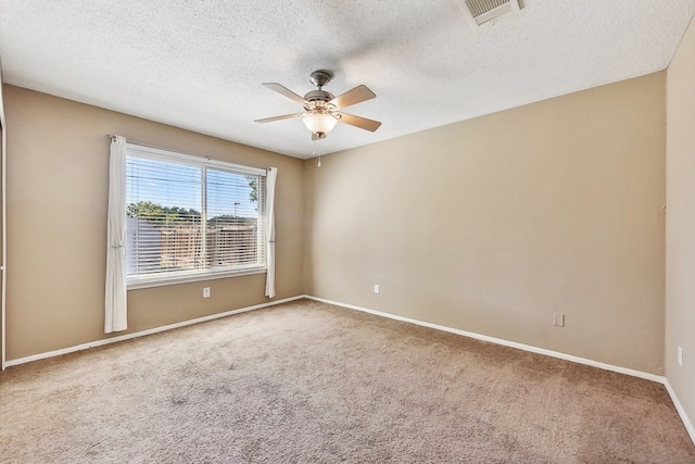 empty room featuring a textured ceiling, carpet, and ceiling fan