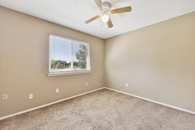 spare room featuring carpet floors, a textured ceiling, and ceiling fan