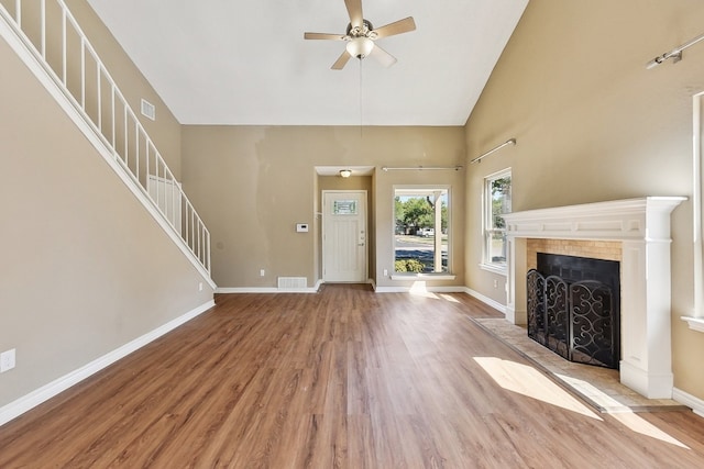 unfurnished living room featuring ceiling fan, high vaulted ceiling, and hardwood / wood-style flooring