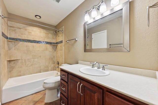 full bathroom featuring tiled shower / bath combo, vanity, toilet, and tile patterned floors