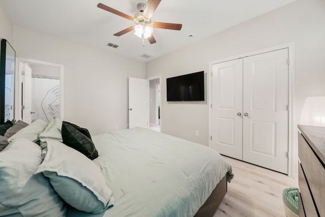 bedroom featuring ceiling fan, a closet, and light hardwood / wood-style floors