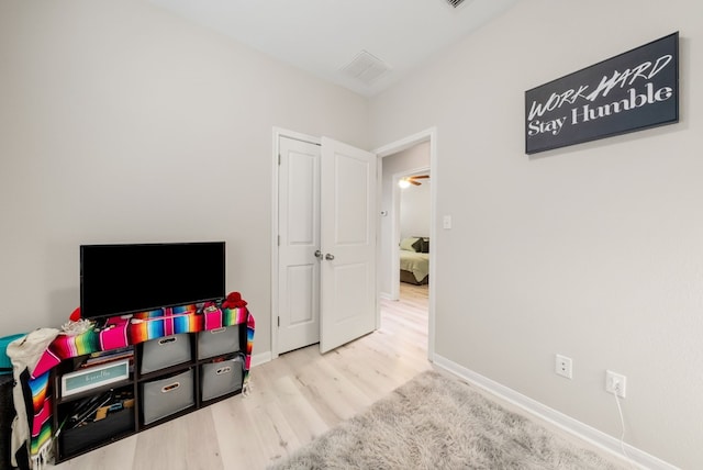 recreation room with light hardwood / wood-style flooring and ceiling fan