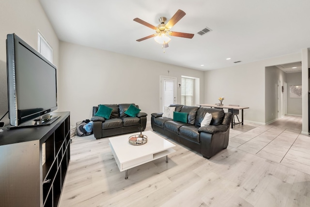 living room featuring light hardwood / wood-style floors and ceiling fan