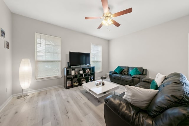 living room featuring ceiling fan and light hardwood / wood-style flooring