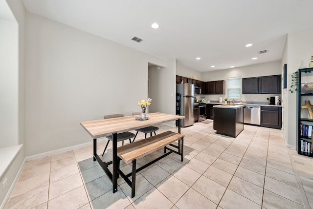 dining area with light tile patterned floors and sink