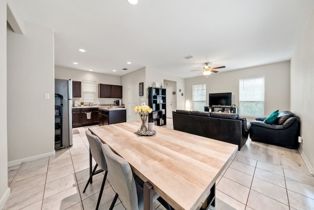 tiled dining area with ceiling fan