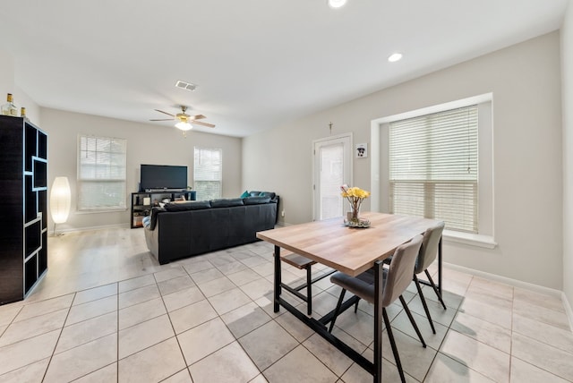 tiled dining space featuring ceiling fan