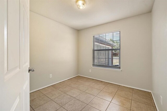 unfurnished room featuring light tile patterned floors