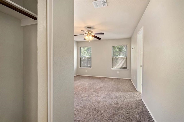 spare room with carpet floors and ceiling fan