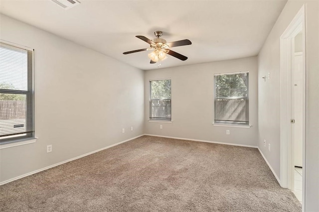 spare room with ceiling fan and carpet flooring